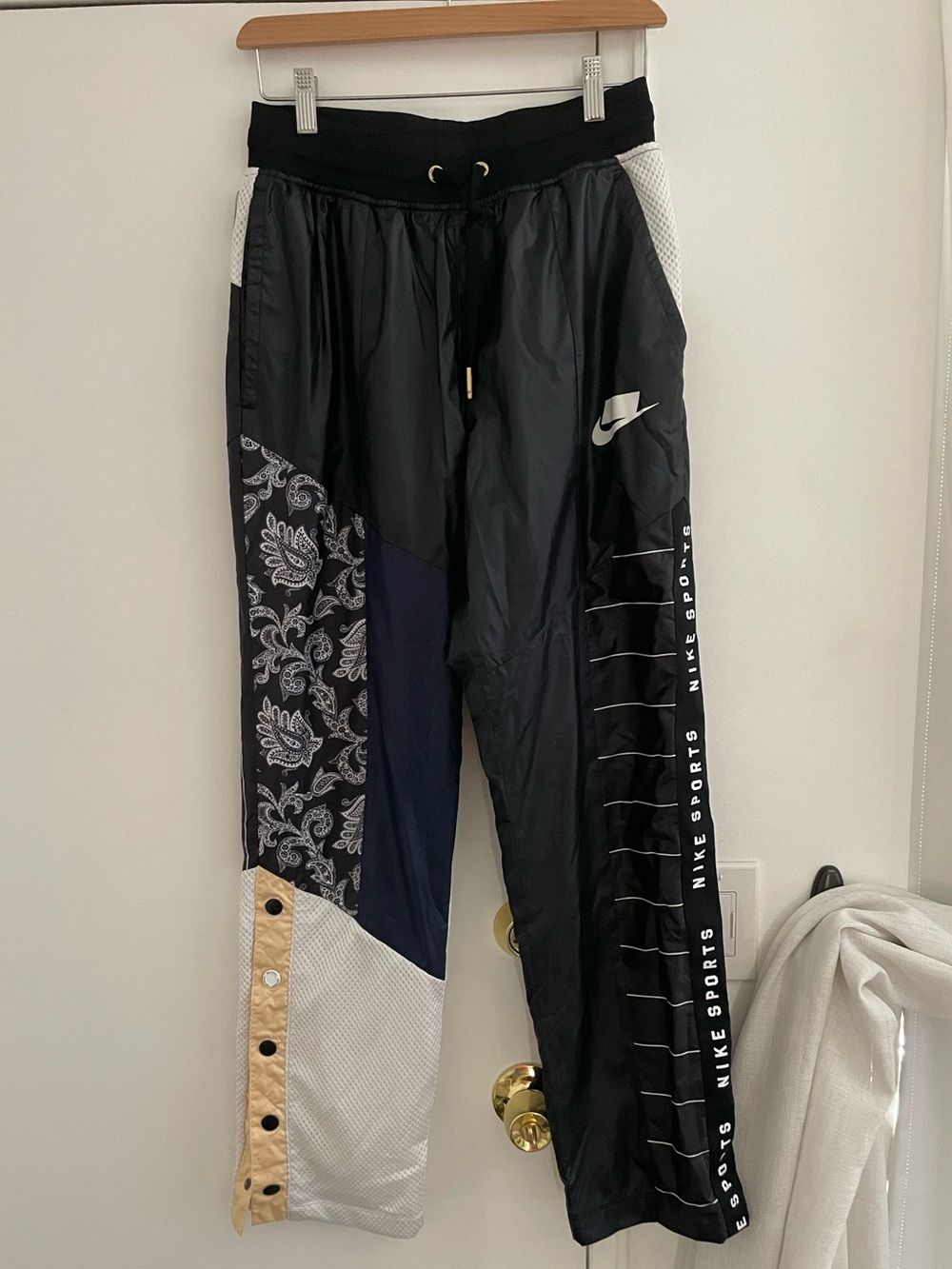 Nike track pants with various patterns, size small